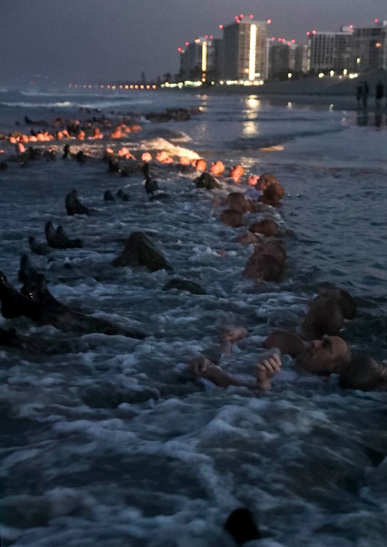 SEAL candidates exercise in the surf.