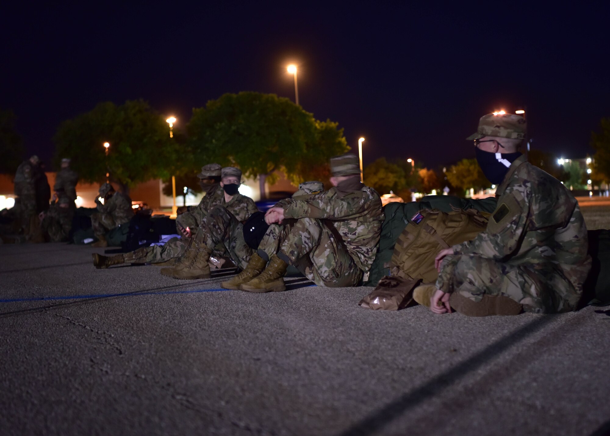Soldiers with the 344 Military Intelligence Battalion wait for a bus on Goodfellow Air Force Base, Texas, May 5, 2020. The Soldiers recently graduated from intelligence training and received their initial operational assignments. (U.S. Air Force photo by Staff Sgt. Chad Warren)