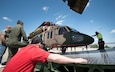 Team members from a Huntsville-based defense industry contractor, SES-i, who refurbished these two UH-60 Black Hawk helicopters for Afghanistan under a U.S Army Security Assistance Command foreign military sales case, prepare to upload the helicopters into an Antonov AN-124, at the airfield in Huntsville, Alabama, April 26, 2019.  US Army photo by Richard Bumgardner, USASAC Public Affairs.