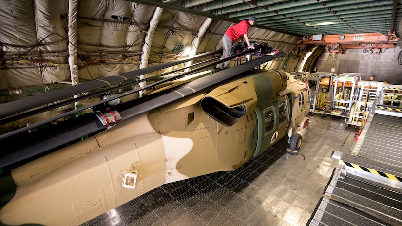 eam members from a Huntsville-based defense industry contractor, SES-I, who refurbished these two UH-60 Black Hawk helicopters for Afghanistan under a U.S Army Security Assistance Command foreign military sales case, upload the helicopters into an Antonov AN-124, at the airfield in Huntsville, Alabama, April 26, 2019.  US Army photo by Richard Bumgardner, USASAC Public Affairs.