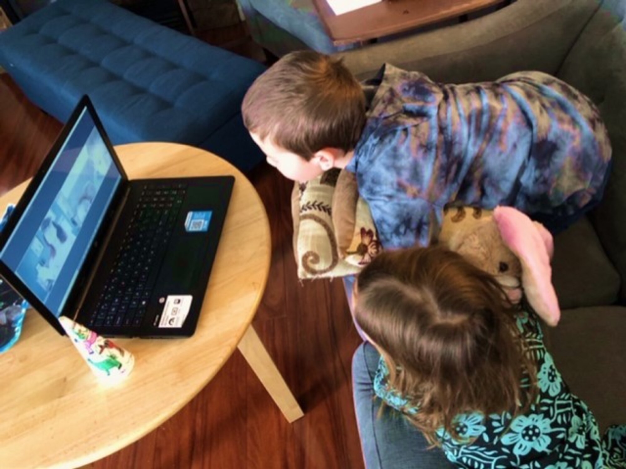 Peterson Air Force Base, Colo.— Zechariah, 9, (top) and Angelica, 7, (bottom), children of Kristi Gutzman, attend the daily virtual read aloud story time hosted by Anna Dunson, the 21st Force Support Squadron library director, at Peterson Air Force Base, Colorado on April 13, 2020. The library has a number of virtual events that families can participate in to connect with one another and continue fostering that sense of community that Team Pete has. (Photo courtesy of Kristi Gutzman).