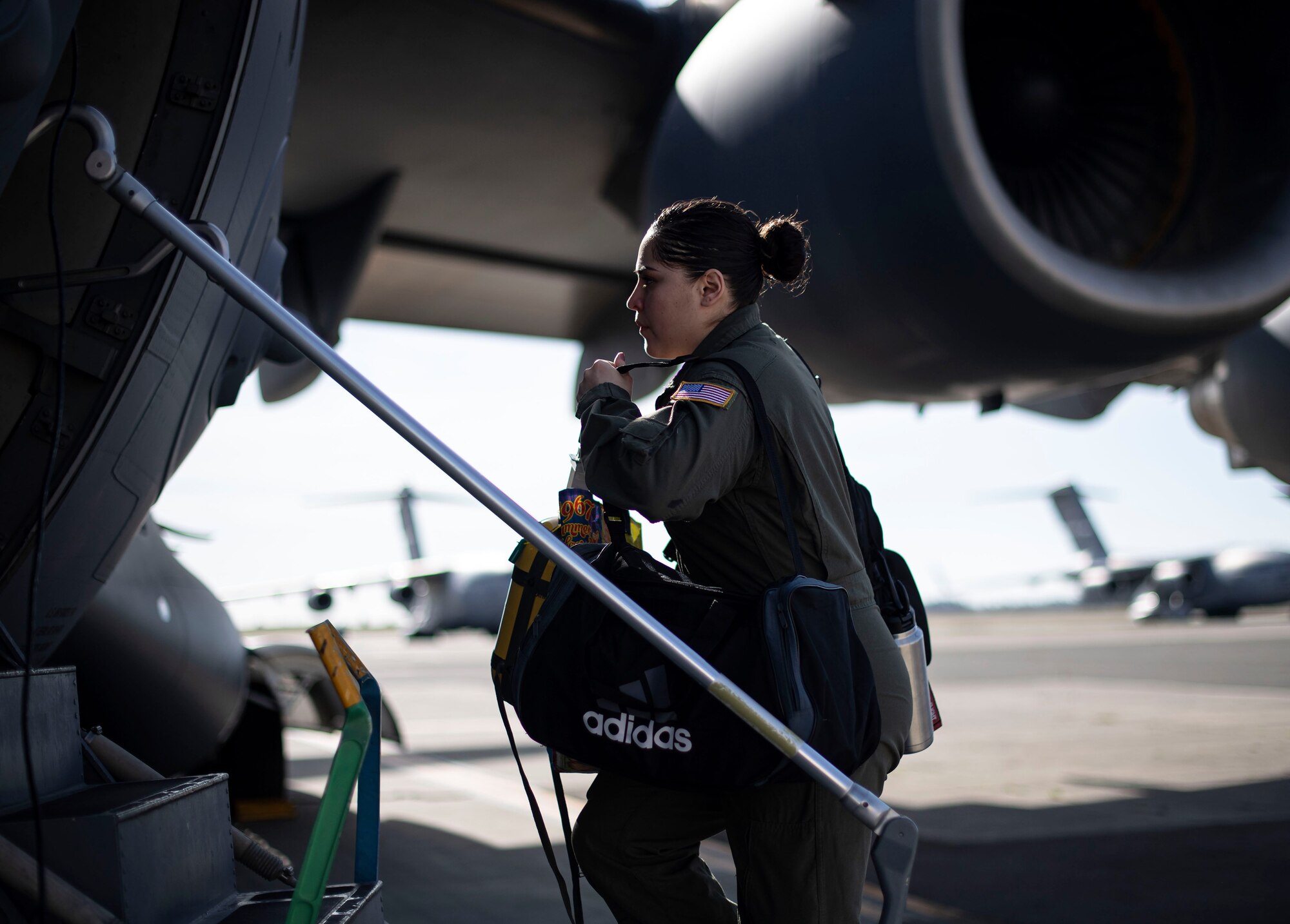 U.S. Air Force Staff Sgt. Maranda Trujillo, 21st Airlift Squadron instructor loadmaster, boards a C-17 Globemaster III April 27, 2020, at Travis Air Force Base, California. Trujillo was among the 21st AS aircrew tasked with transporting four Transport Isolation System capsules from Joint Base Charleston, South Carolina, to Travis AFB. TIS capsules, which were initially engineered in response to the Ebola virus in 2014, allow the transport of individuals with highly contagious diseases without infecting any other passengers or aircrew on the aircraft. (U.S. Air Force photo by Senior Airman Christian Conrad)