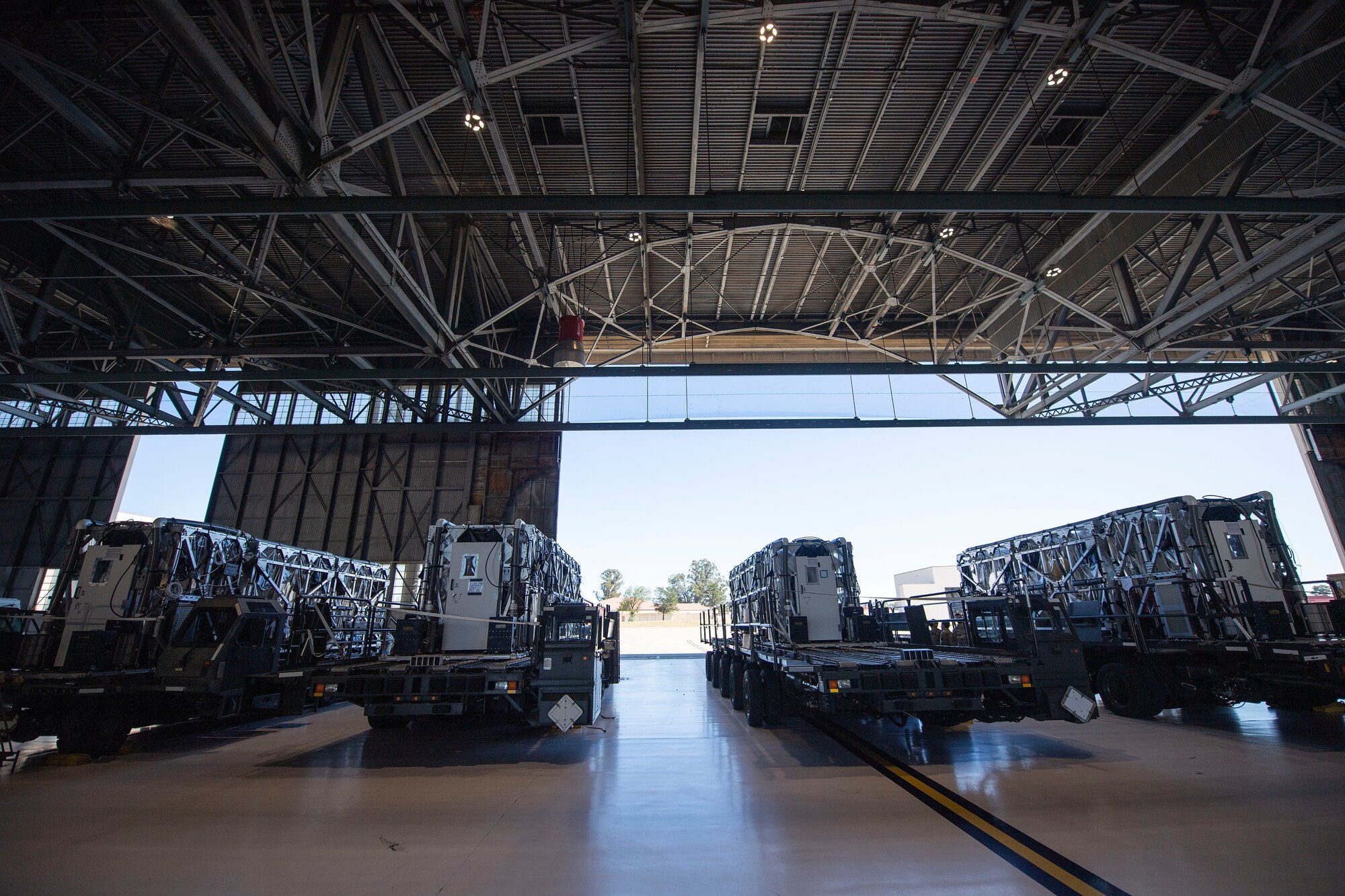 Transport Isolation System capsules are positioned on respective cargo K loaders in a hangar April 28, 2020, at Travis Air Force Base, California. TIS capsules, which were initially engineered in response to the Ebola virus in 2014, allow the transport of individuals with highly contagious diseases without infecting any other passengers or aircrew on the aircraft. (U.S. Air Force photo by Senior Airman Christian Conrad)