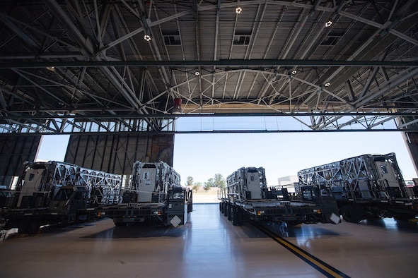 Transport Isolation System capsules are positioned on respective cargo K loaders in a hangar April 28, 2020, at Travis Air Force Base, California. TIS capsules, which were initially engineered in response to the Ebola virus in 2014, allow the transport of individuals with highly contagious diseases without infecting any other passengers or aircrew on the aircraft. (U.S. Air Force photo by Senior Airman Christian Conrad)