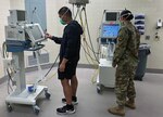 Capt. Farley Raquel and Sgt. Rebecca Hummer do a system check on ventilators in the U.S. Army Institute of Surgical Research “Victory” Intensive Care Unit at Joint Base San Antonio-Fort Sam Houston.