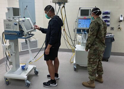 Capt. Farley Raquel and Sgt. Rebecca Hummer do a system check on ventilators in the U.S. Army Institute of Surgical Research “Victory” Intensive Care Unit at Joint Base San Antonio-Fort Sam Houston.
