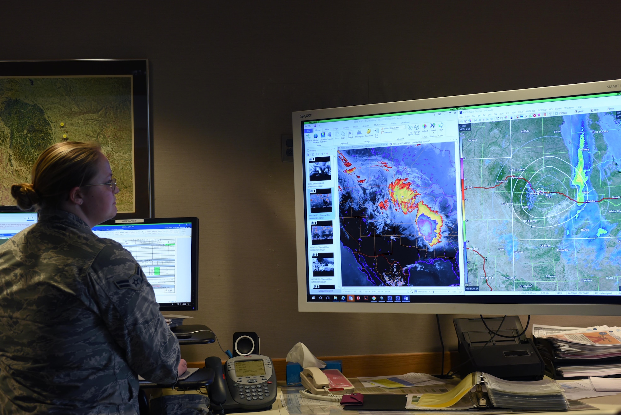 Airman 1st Class Wendi Mueller, a 28th Operations Support Squadron weather apprentice, reviews radar imagery for a weather report at Ellsworth Air Force Base, S.D., May 4, 2020. This weather report was used to inform aviators in preparation for a non-stop deployment to the U.S. European Command area of responsibility. (U.S. Air Force photo by Staff Sgt. Hailey Staker)