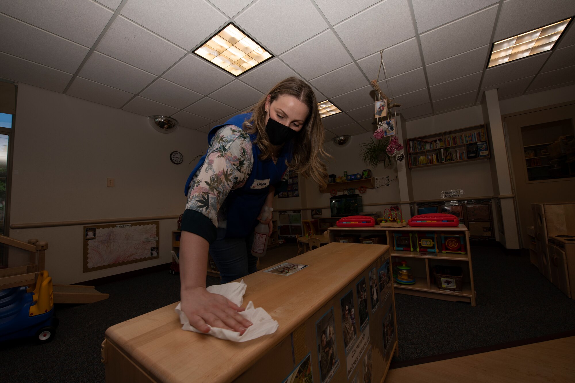 Emilia Williams, 60th Force Support Squadron child and youth program technician, wipes down a shelf May 1, 2020, in a pre-toddler room inside Child Development Center 3 at Travis Air Force Base, California. Since the coronavirus pandemic hit the United States, the CDC staff at Travis AFB implemented more frequent cleaning of surfaces to prevent the spread of COVID-19. (U.S. Air Force photo by Tech. Sgt. James Hodgman)