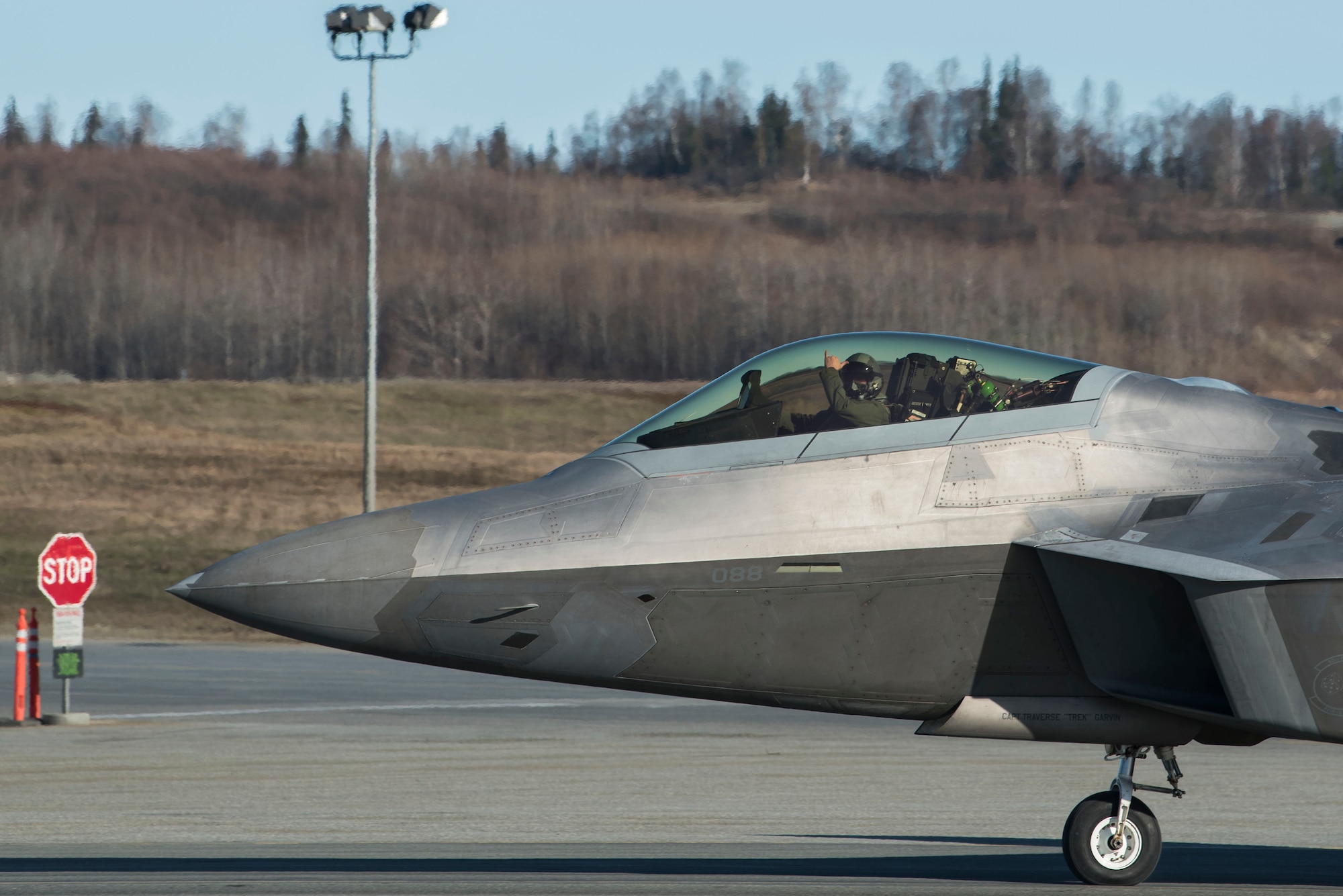 A U.S. Air Force F-22 Raptor taxis onto the runway prior to an elephant walk, May 5, 2020, at Joint Base Elmendorf-Richardson, Alaska. This event displayed the ability of the 3rd Wing, 176th Wing and the 477th Fighter Group to maintain constant readiness throughout COVID-19 by Total Force Integration between active-duty, Guard and Reserve units to continue defending the U.S. homeland and ensuring a free and open Indo-Pacific.