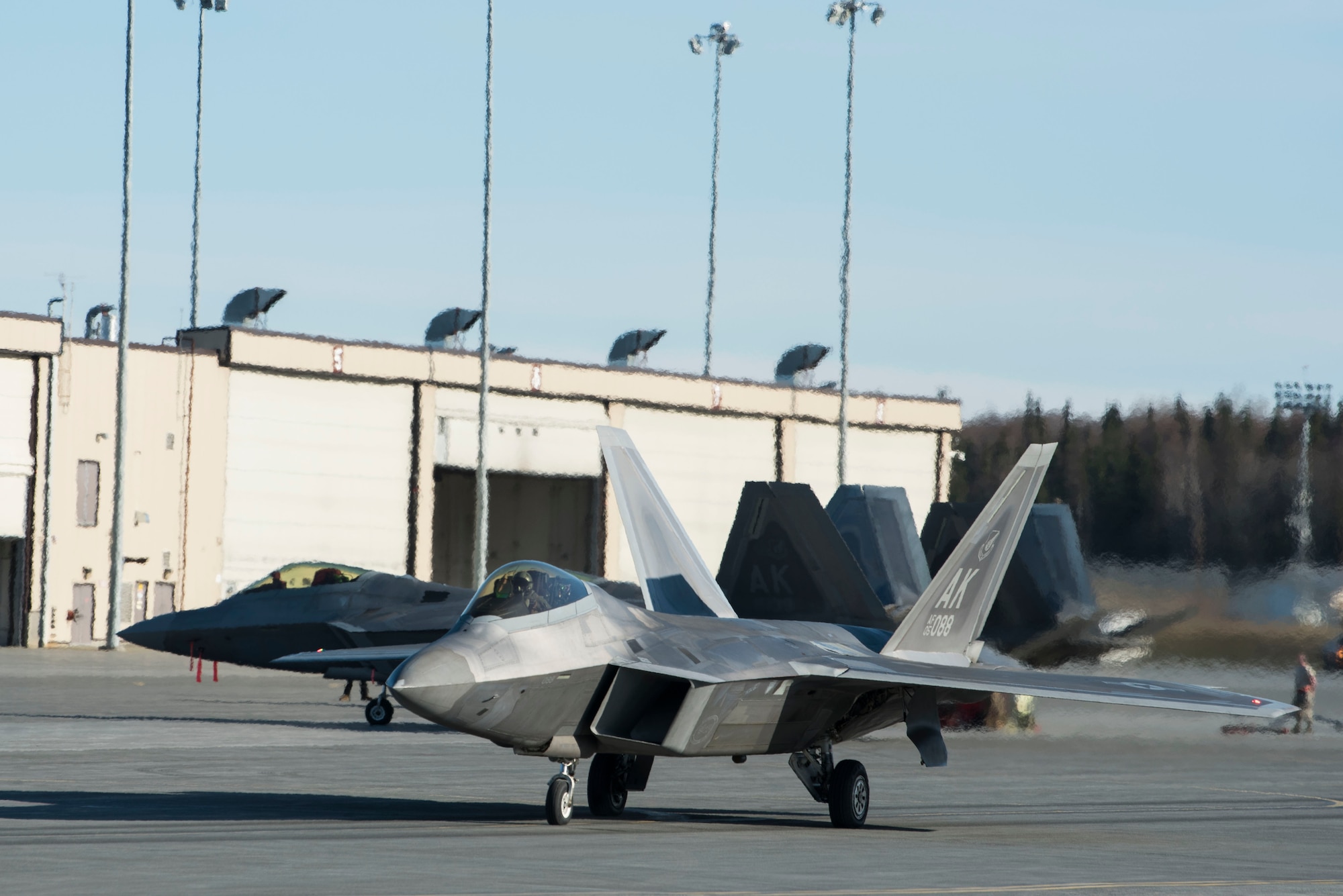 A U.S. Air Force F-22 Raptor taxis onto the runway prior to an elephant walk, May 5, 2020, at Joint Base Elmendorf-Richardson, Alaska. This event displayed the ability of the 3rd Wing, 176th Wing and the 477th Fighter Group to maintain constant readiness throughout COVID-19 by Total Force Integration between active-duty, Guard and Reserve units to continue defending the U.S. homeland and ensuring a free and open Indo-Pacific.