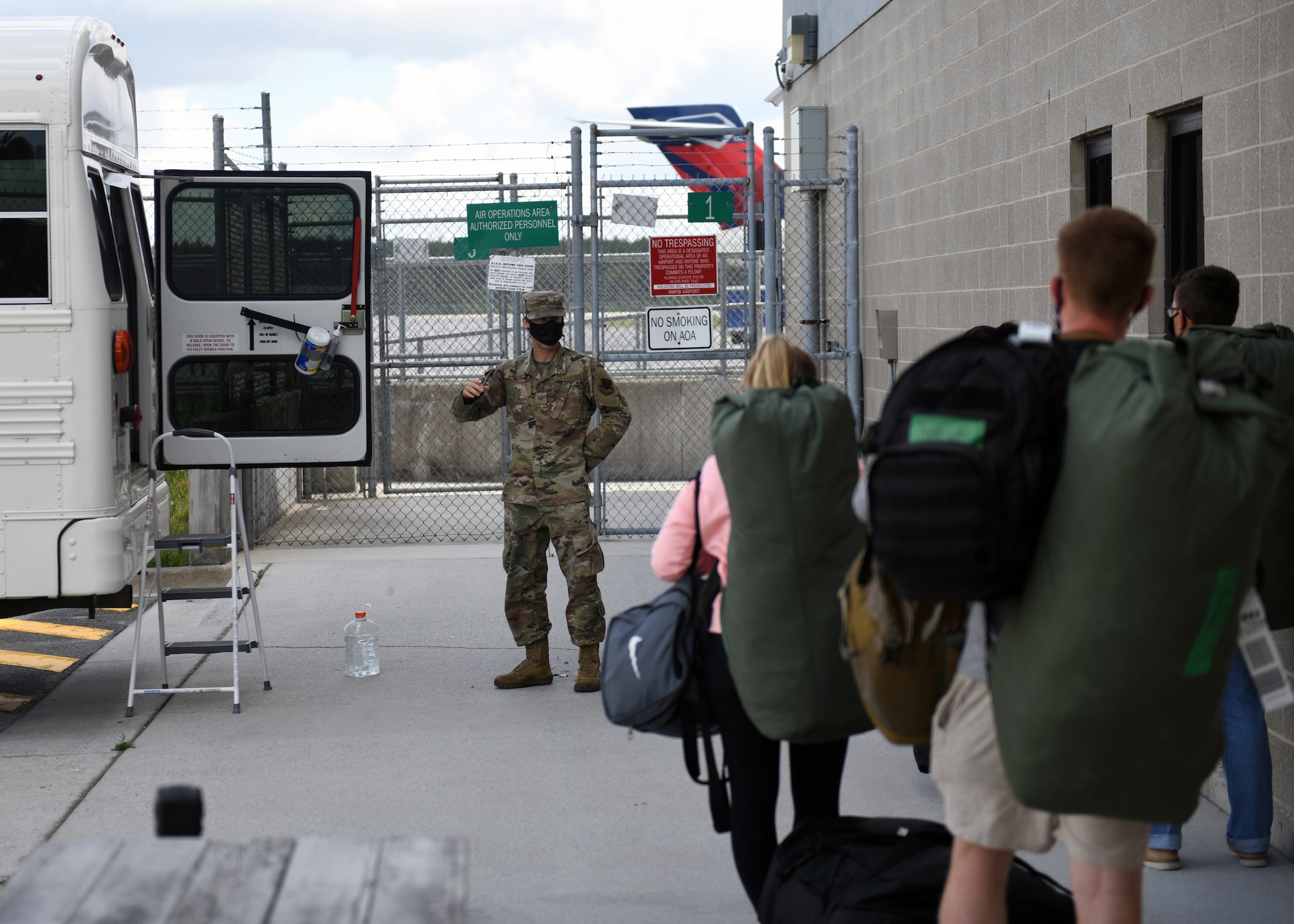 Inprocessing Airmen are directed towards transportation at the Northwest Florida Beaches International Airport in Panama City, Florida, May 5, 2020. During the COVID-19 Pandemic, Tyndall Air Force Base requires technical training graduates to quarantine for 14 days upon arrival to minimize the spread of the virus. (U.S. Air Force photo by Brad Sturk)