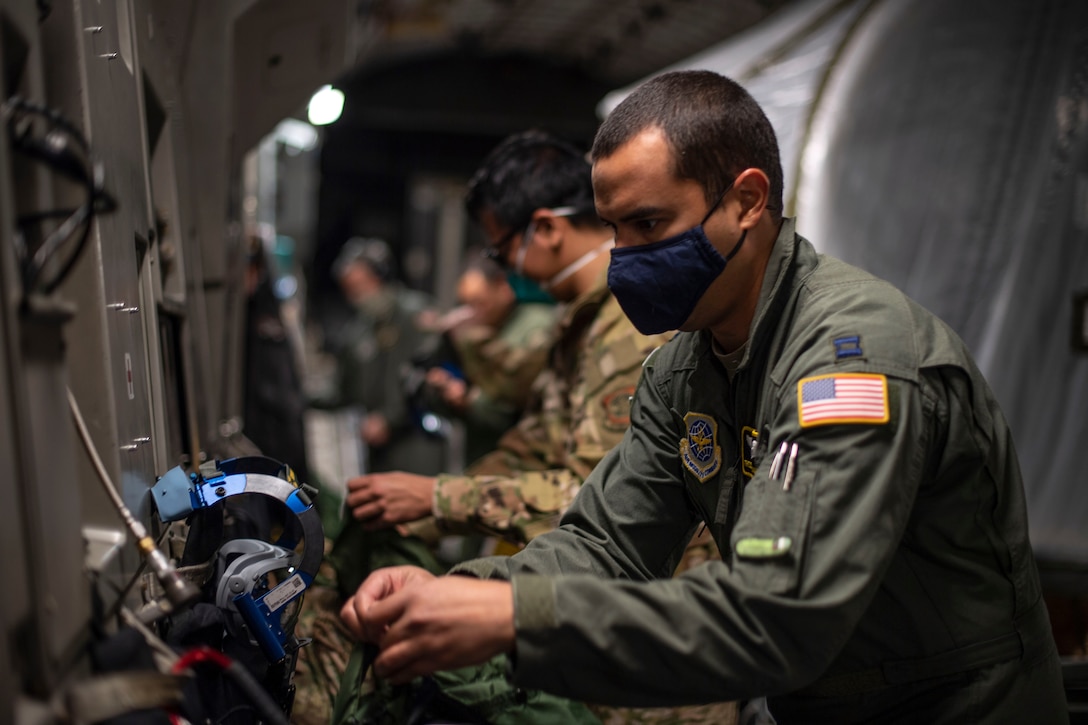 U.S. Air Force Capt. Freddy Roman-Otero, 43rd Aeromedical Evacuation Squadron flight nurse, checks his equipment as part of a pre-flight procedure April 27, 2020, at Travis Air Force Base, California. Roman-Otero is one of two 43rd AES representatives called to perform training on the Transport Isolation System capsule. This training coincided with the 21st Airlift Squadron’s transfer of four TIS capsules from Joint Base Charleston, South Carolina, to Travis AFB in an effort to bolster the U.S. Air Force’s AE capabilities. . (U.S. Air Force photo by Senior Airman Christian Conrad)
