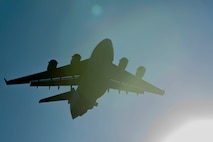 A U.S. Air Force C-17 Globemaster III flies over the flightline during an elephant walk, May 5, 2020, at Joint Base Elmendorf-Richardson, Alaska. The large show-of-force demonstrated the wings’ rapid mobility capabilities and response readiness during COVID-19 and also highlighted the ability to generate combat airpower at a moment’s notice to ensure regional stability throughout the North American Aerospace Defense Command Region and Indo-Pacific.