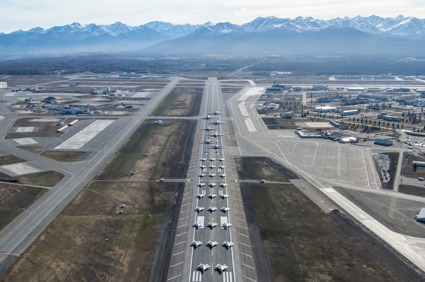 U.S. Air Force aircraft assigned to the 3rd Wing, 176th Wing and 477th Fighter Group participate in a close formation taxi, known as an Elephant Walk, at Joint Base Elmendorf-Richardson, Alaska, May 5, 2020. The large show-of-force demonstrated the wings’ rapid mobility capabilities and response readiness during COVID-19 and also highlighted the ability to generate combat airpower at a moment’s notice to ensure regional stability throughout the North American Aerospace Defense Command Region and Indo-Pacific. Aircraft included F-22 Raptors, C-17 Globemaster IIIs, E-3 Sentrys, C-12F Hurons, C-130J Super Herculeses and HH-60G Pave Hawks.