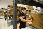 NAPLES, Italy (April 30, 2020) Fransesco Ciccarelli, postal clerk (right), and Logistics Specialist Seaman Oralia Ortiz sort and organize incoming mail at the Naval Support Activity (NSA) Naples Support Site post office, attached to Naval Supply Systems Command Fleet Logistics Center (NAVSUP FLC) Sigonella, April 30, 2020. Commander, U.S. Naval Forces Europe-Africa/ U.S. 6th Fleet, headquartered in Naples, Italy, oversees joint and naval operations, often in concert with Allied, joint, and interagency partners, in order to advance U.S. national interests and security and stability in Europe and Africa. (U.S. Navy photo by Mass Communication Specialist Chief Justin Stumberg/Released)