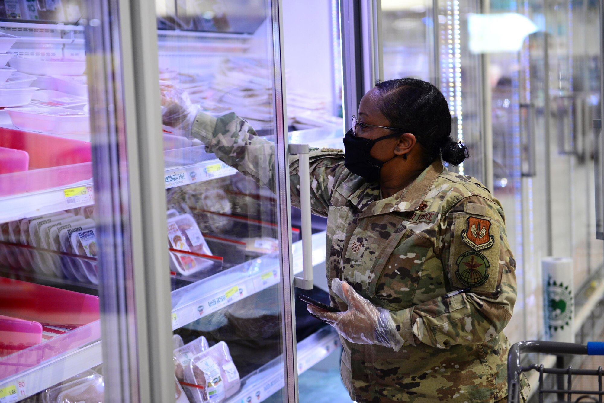 U.S. Air Force Tech. Sgt. Kahlia Rainer, volunteer, retrieves ground turkey at the commissary on Aviano Air Base, Italy, April 18, 2020. Rainer is one of more than 170 volunteers who stepped up to assist those in need by delivering groceries during the battle against COVID-19. (U.S. Air Force photo by Tech. Sgt. Tory Cusimano)