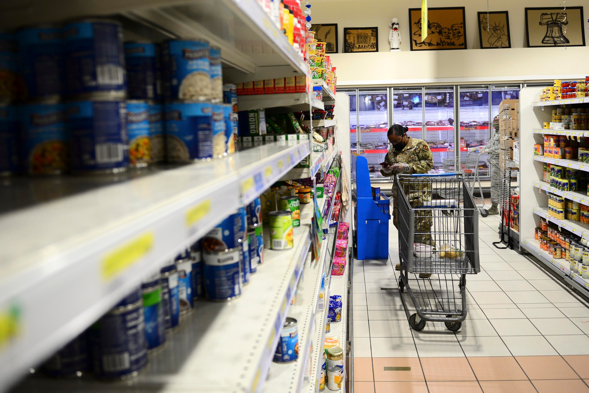 U.S. Air Force Tech. Sgt. Kahlia Rainer, volunteer, checks a grocery list at the commissary on Aviano Air Base, Italy, April 18, 2020. Spouses and dependents of active duty members unable to shop for themselves due to restrictions in place during the ongoing battle against COVID-19 were able to sign up for the grocery delivery service and send a shopping list to their volunteer. (U.S. Air Force photo by Tech. Sgt. Tory Cusimano)