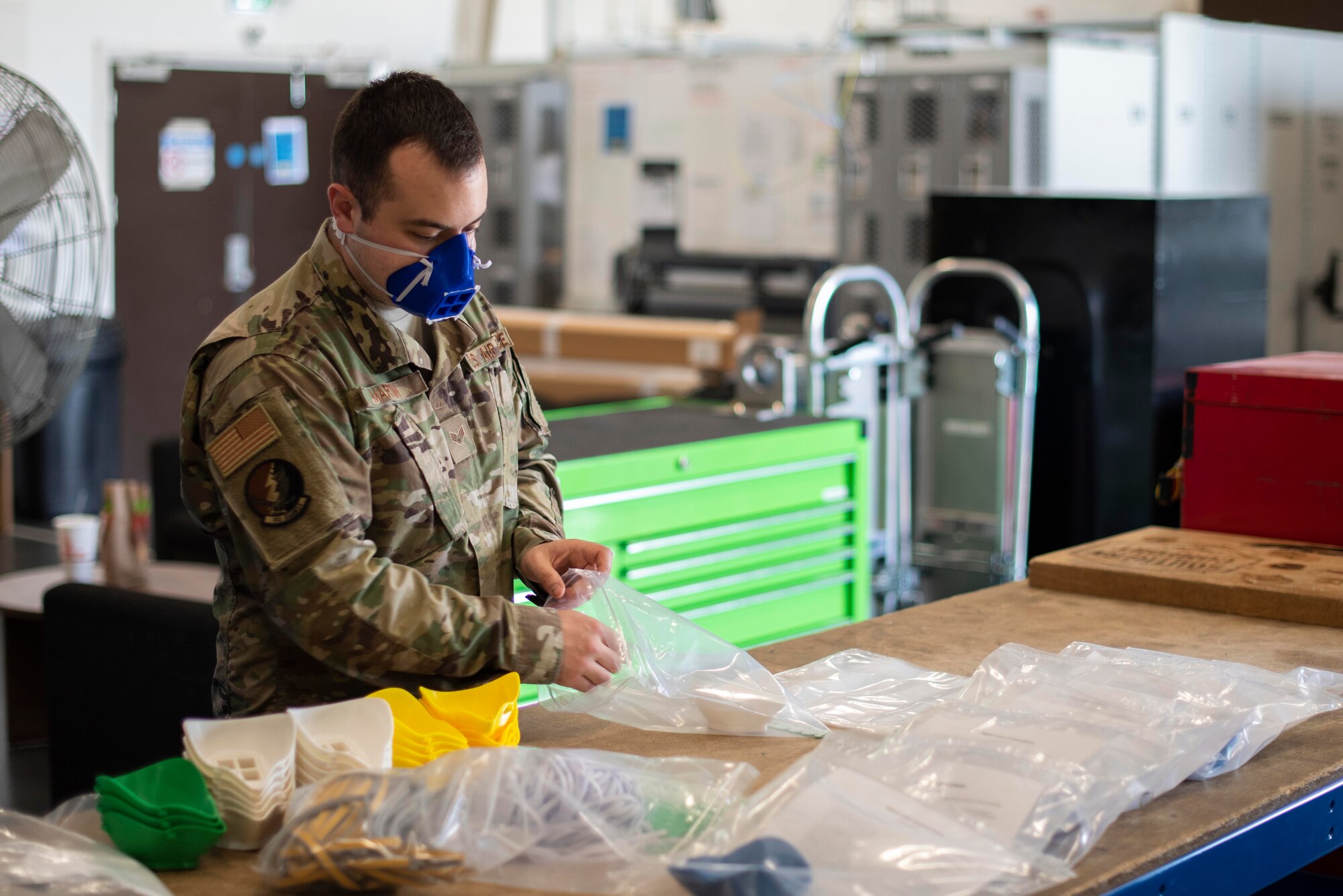 U.S. Air Force Senior Airman Carl Martin, support technician assigned to the 352d Special Operations Aircraft Maintenance Squadron, 352d Special Operations Wing, creates mask kits, April 27, 2020, at RAF Mildenhall, England. Designed to protect wearers from COVID-19, the masks must be assembled after they are printed, a process that involves using warm water to shape the mask to the face. The 352d Special Operations Wing is the sole Air Force special operations unit in the European Theater. (U.S. Air Force photo by Airman 1st Class Joseph Barron)