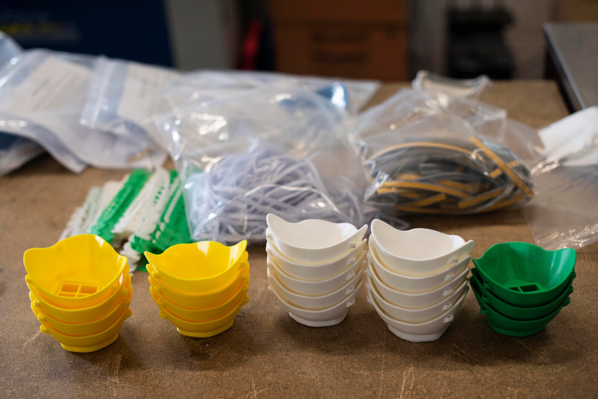 Newly printed face masks and related materials necessary for their use sit on a table inside the 352d Special Operations Aircraft Maintenance Squadron, 352d Special Operations Wing, April 27, 2020, at RAF Mildenhall, England. The masks can be worn to fight the spread of COVID-19 and are made out of 3D printing plastics that can be disinfected with a bleach solution or sanitizing wipes. The 352d Special Operations Wing is the sole Air Force special operations unit in the European Theater.  (U.S. Air Force photo by Airman 1st Class Joseph Barron)