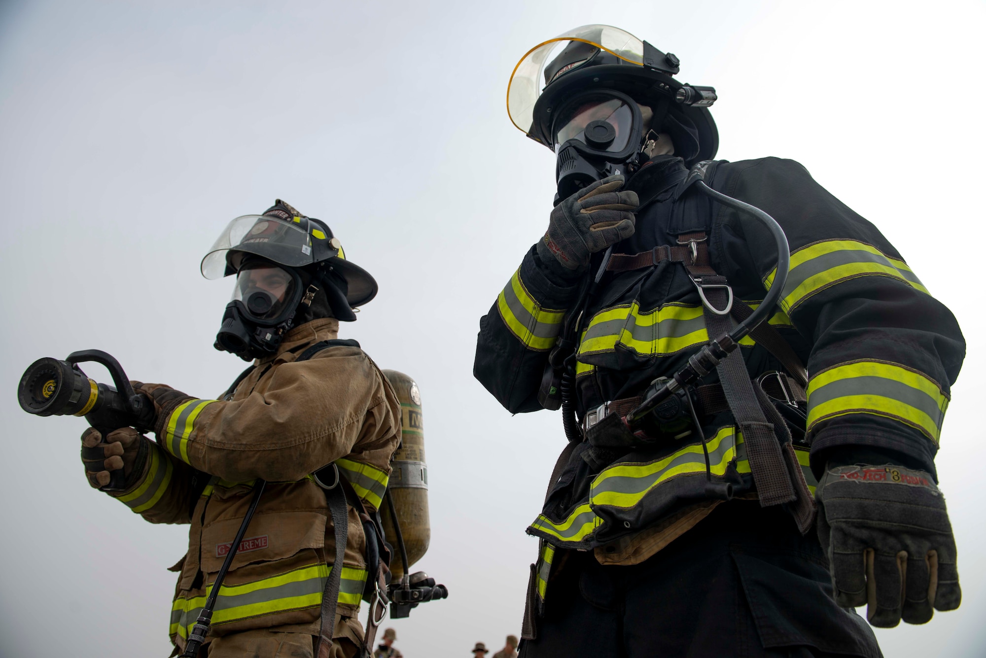 Firefighters from the 386th Expeditionary Civil Engineer Squadron simulate decontamination measures during a training exercise at Ali Al Salem Air Base, Kuwait, May 5, 2020. The exercise was designed to enhance interoperability between multiple first responder teams with the goal of responding, identifying and controlling potential real-world scenarios. (U.S. Air Force photo by Senior Airman JaNae Capuno)