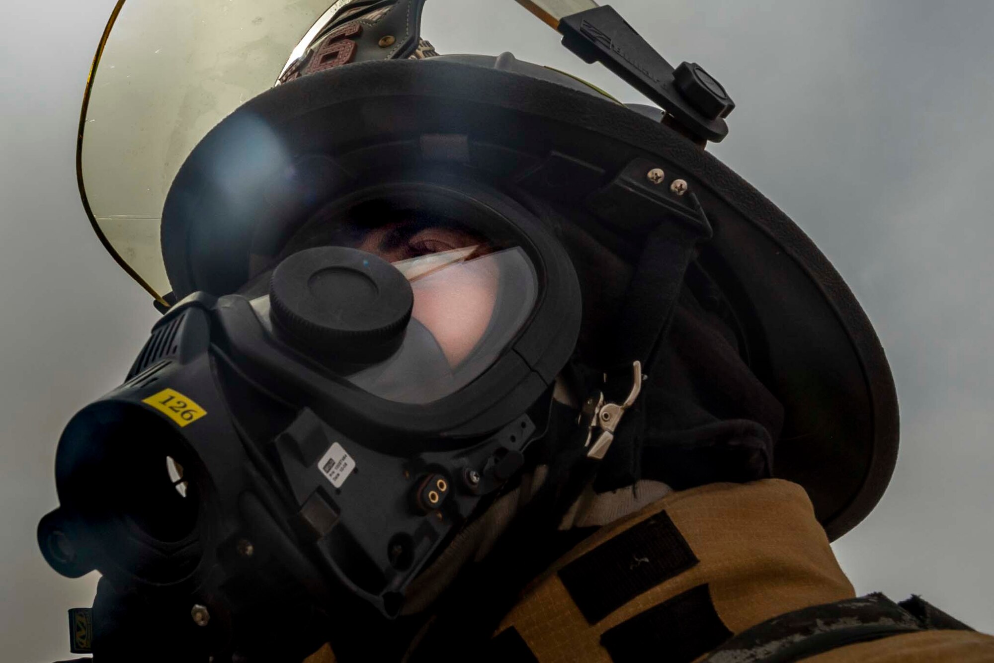 Senior Airman Michael Tuck, 386th Expeditionary Civil Engineer Squadron firefighter, looks up to adjust his mask during an all-hazard training exercise at Ali Al Salem Air Base, Kuwait, May 5, 2020. The exercise was designed to enhance interoperability between multiple firstresponder teams with the goal of responding, identifying and controlling potential real-world scenarios. (U.S. Air Force photo by Senior Airman JaNae Capuno)