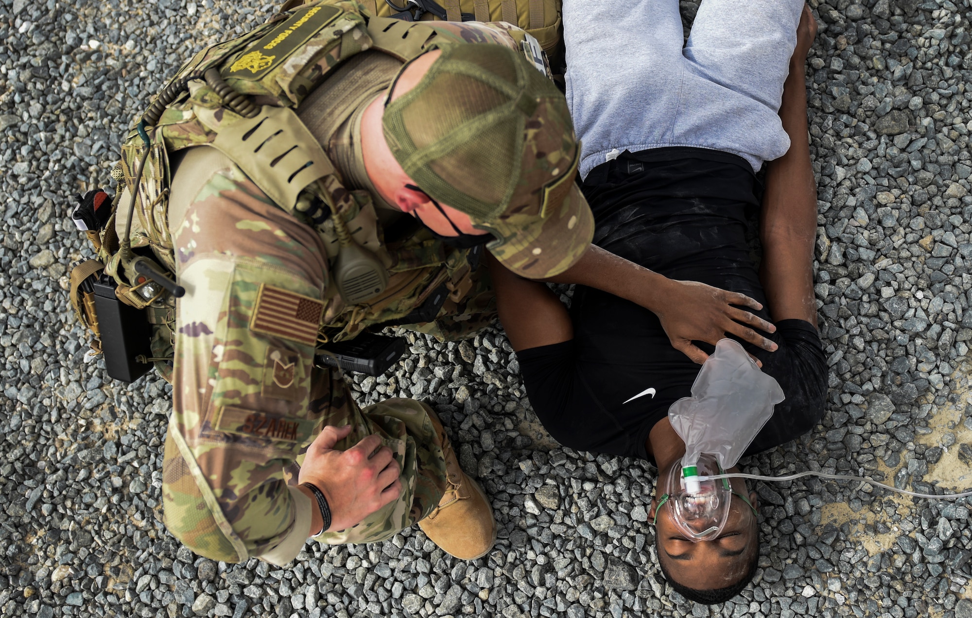 A 386th Expeditionary security Forces Squadron member assists a simulated casualty during an all hazard exercise at Ali Al Salem Air Base, Kuwait, May 5, 2020. Responding agencies practiced their skills together to build cohesion and learn each other's capabilities during the all-hazard response exercise. (U.S. Air Force photo by Senior Airman Kevin Tanenbaum)