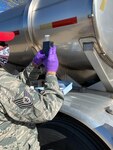 A member of the New Mexico National Guard checks the purity of a truckload of water. Airmen and Soldiers of the New Mexico National Guard Joint Task Force are supplying food and water to New Mexico communities during the COVID-19 response mission.