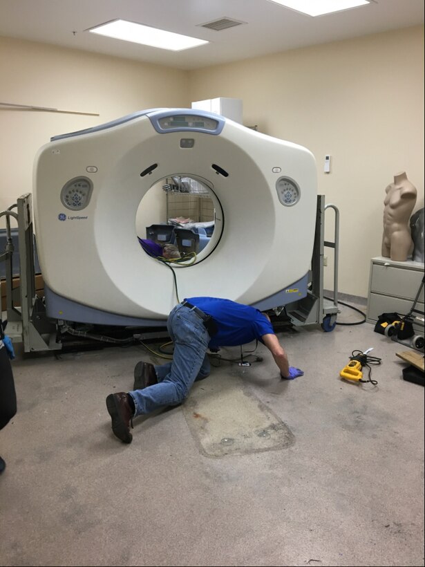 Contractors prepare to remove the old CT scanner out of the AFMES’ autopsy suite at the Armed Forces Medical Examiner System, Dover Air Force Base, Delaware, March 2, 2020. AFMES received a new custom built scanner in April due to the dated technology and regular failures that were impeding operations with the old CT scanner. (Courtesy photo)