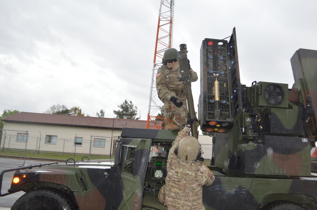 Soldiers load a missile into a short-range air defense missile system.