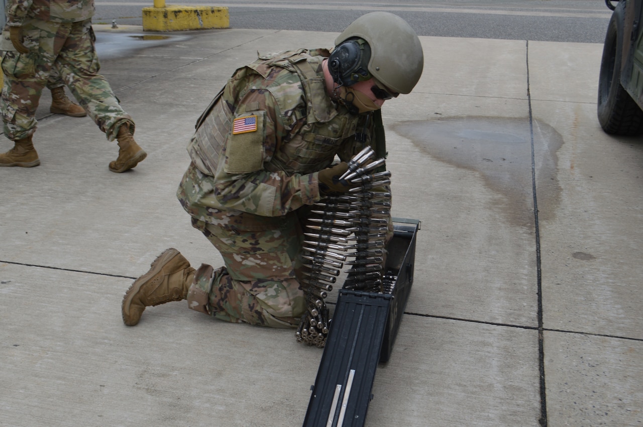 A soldier loads ammo into a magazine.