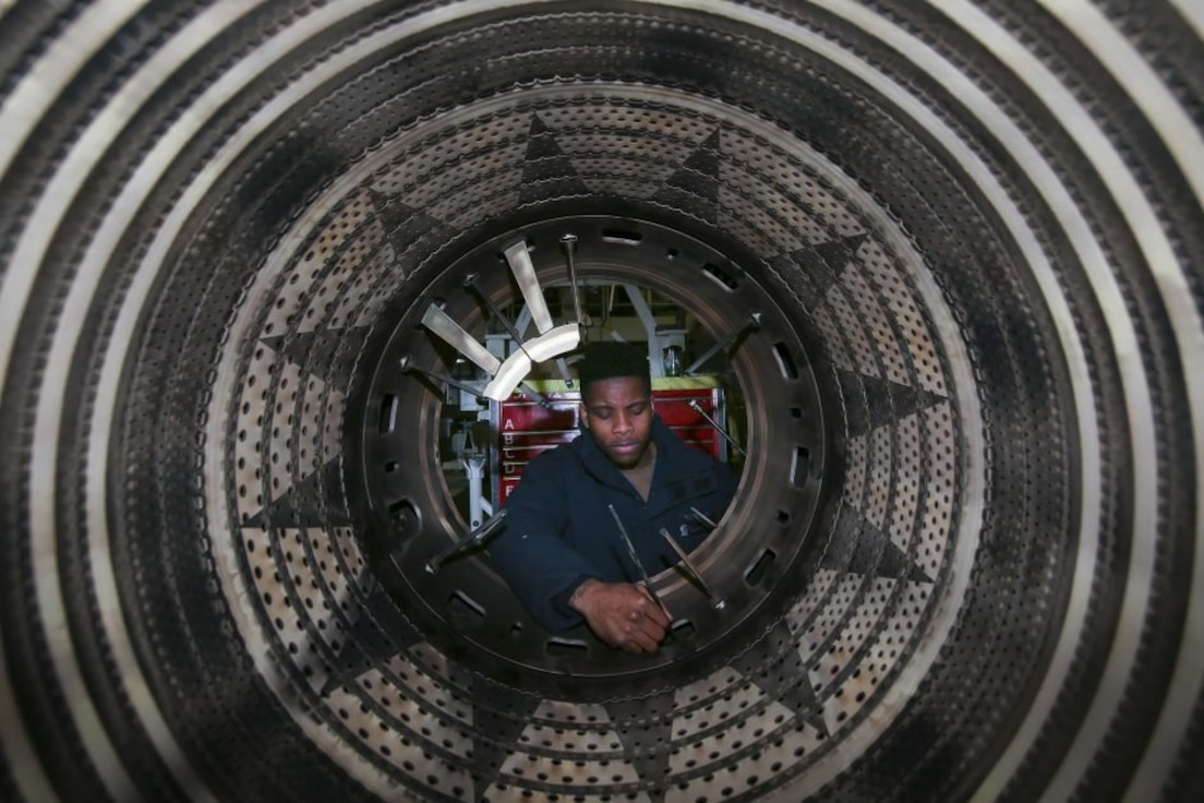 Aviation Machinist’s Mate 2nd Class Chinagozi Amasiatu performs maintenance on spring bars of an F/A-18 Super Hornet jet engine aboard the Nimitz-class aircraft carrier USS Abraham Lincoln (CVN 72) on Feb. 28, 2019