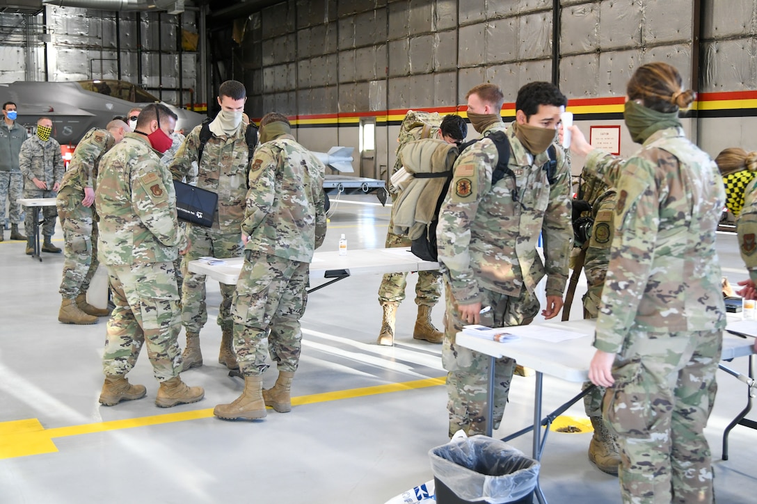 Airmen from the active duty 388th and Reserve 419th Fighter Wings walk through a health screening May 7, 2020, at Hill Air Force Base, Utah, following a six-month deployment to the Middle East.