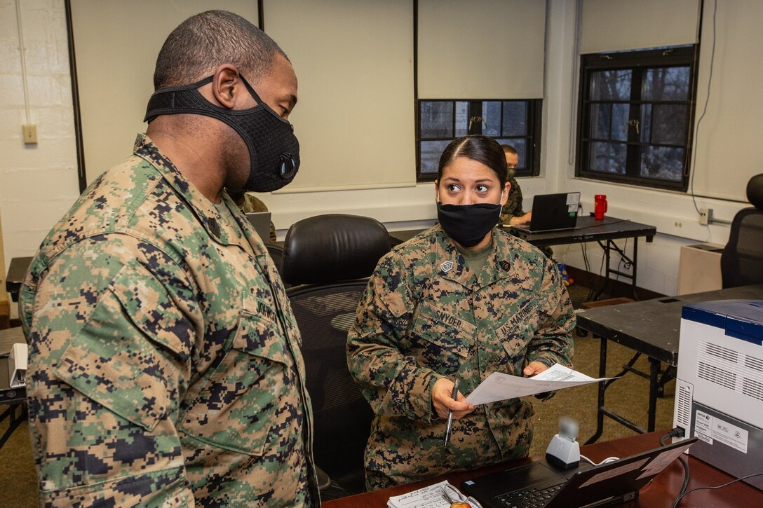 Marines with II Marine Expeditionary Force, Task Force Northeast, and augmented service members command and control Title 10 forces in support of the Federal Emergency Management Agency at Fort Devens, Mass., April 26, 2020.  U.S. Northern Command, through U.S. Army North, remains committed to providing flexible Department of Defense support to FEMA for the whole-of-nation COVID-19 response. (U.S. Marine Corps photo by Staff. Sgt. Hector de Jesus) (This photo has been altered for security purposes by blurring out identification badges.)