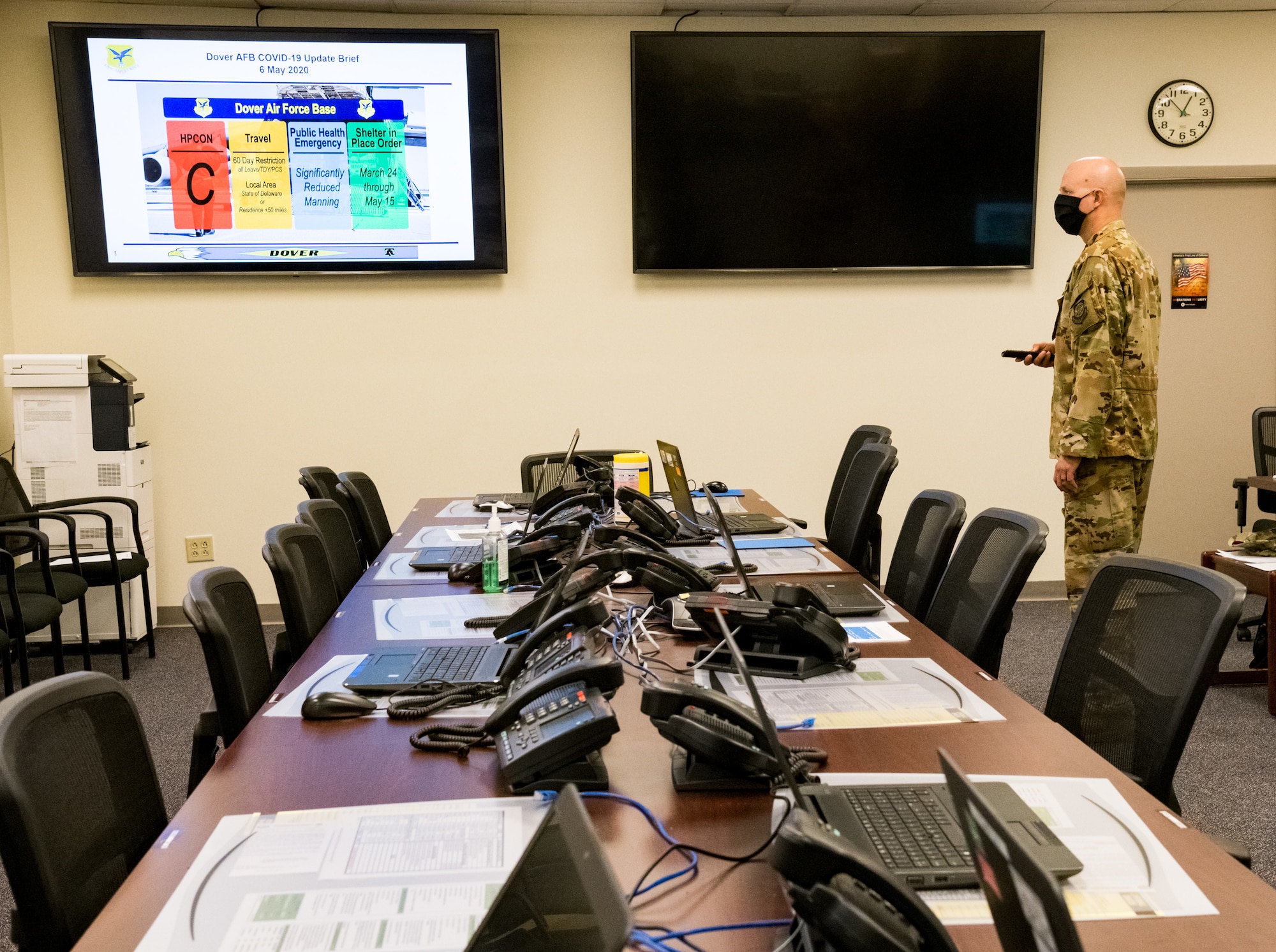 Battle staff facilitator Master Sgt. Jeremy Gerberick, 436th Airlift Wing plans and programs superintendent, sets up slides in the alternate Installation Control Center a for weekly teleconference between the wing commander, command chief and group commanders and superintendents May 6, 2020, on Dover Air Force Base, Delaware. The battle staff resorted to virtual meetings after Shelter-In-Place orders were put into place in mid-March to help mitigate the spread of COVID-19. Following the first briefing, a second briefing is held to disseminate current information to squadron commanders. (U.S. Air Force photo by Roland Balik)