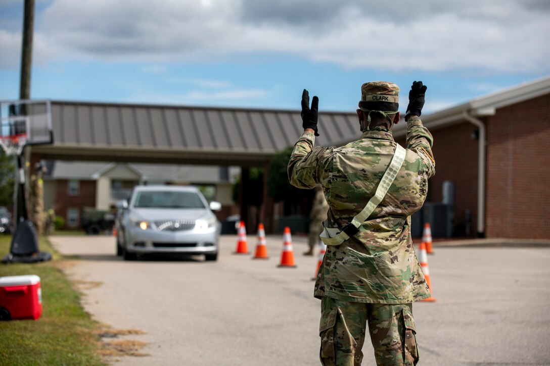 A soldier directing traffic.