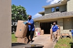 Household goods inspector Faata Leafa performs an inspection of a household goods packout performed by Aloha International. They all are practicing social distancing and wearing facemasks.