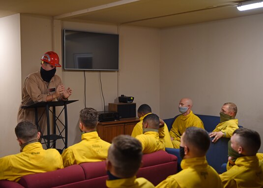 U.S. Air Force Staff Sgt. Jonathan Kidd, 312th Training Squadron Block III instructor, briefs his class on their upcoming exercise at the Louis F. Garland Department of Defense Fire Academy on Goodfellow Air Force Base, Texas, May 6, 2020. The class was required to use face masks at all times to protect themselves and others from COVID-19. (U.S. Air Force photo by Airman 1st Class Ethan Sherwood)