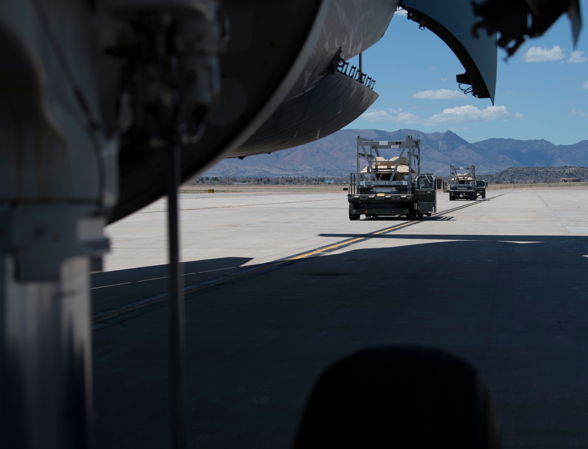 Airmen from the 21st Logistics Readiness Squadron operate K Loaders to put multiple cargo pallets onto a C-5M Super Galaxy from Travis Air Force Base, California, April 27, 2020 on Peterson AFB, Colorado. The 21st LRS loaded the cargo to assist in a Space and Missile Systems Center mission to bring supplies to support down range warfighters. While directly aiding the SMC Rapid Reaction Branch, the supplies will support five combatant commands. (U.S. Air Force photo by Airman 1st Class Andrew J. Bertain)