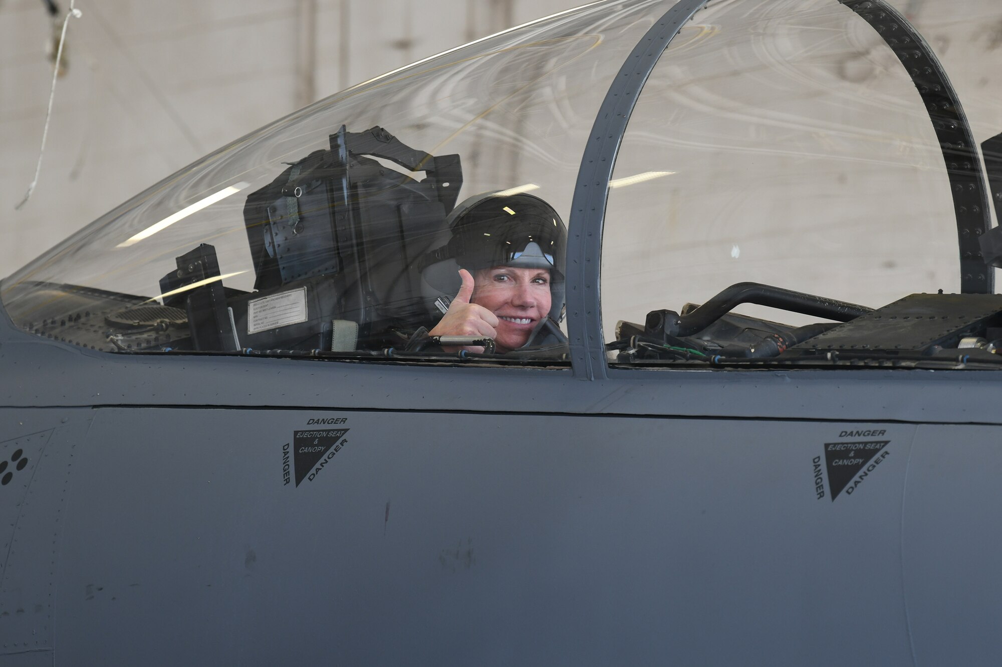 Photo shows Col. Farrell sitting in the cockpit of an F-15 giving a thumbs up.