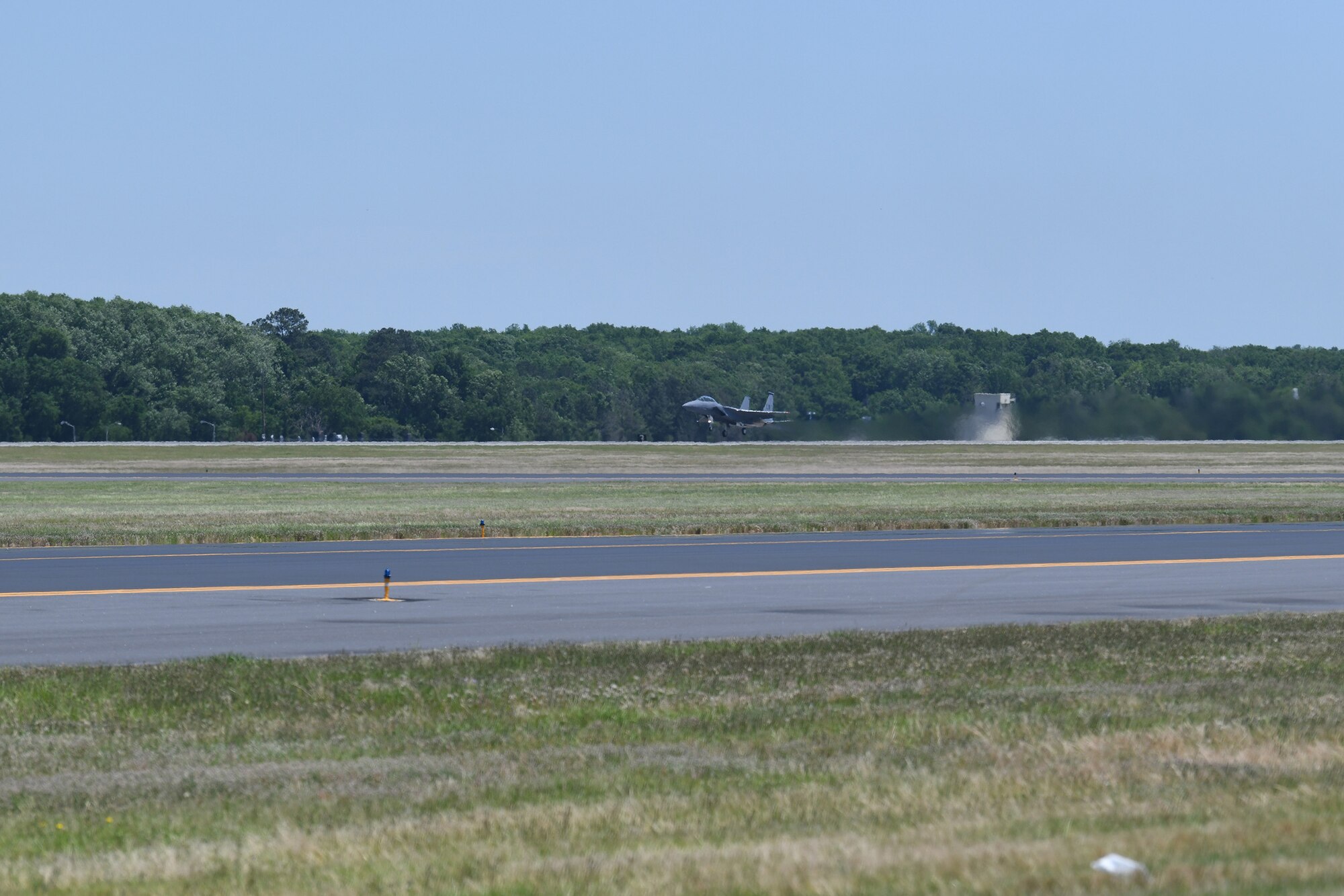 Photo shows an F-15 right as it leaves the ground on take off.