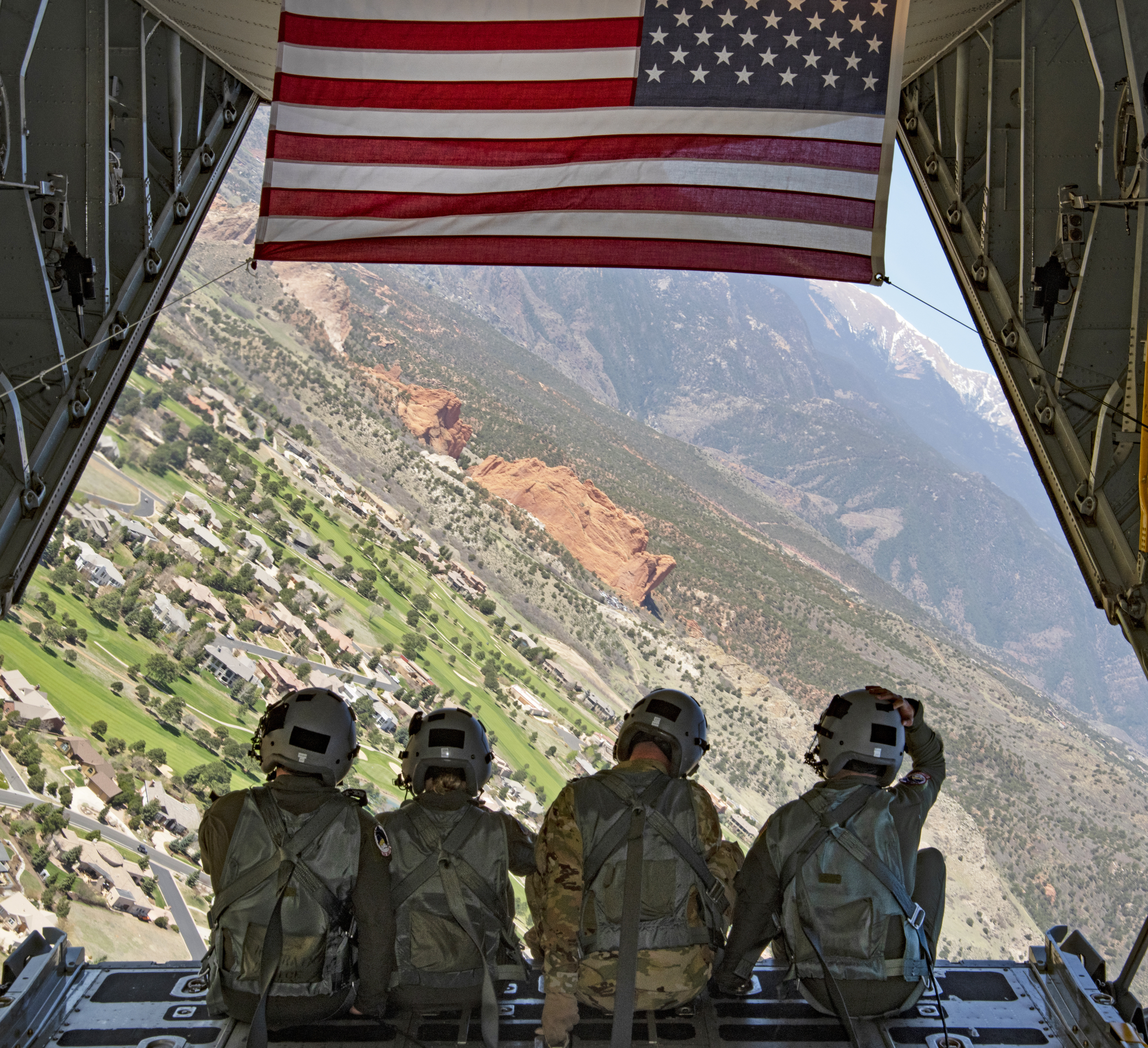 Image shows four people on ramp of large aircraft while in flight