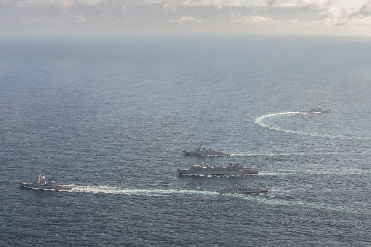 U.S. and British naval ships transit the ocean.