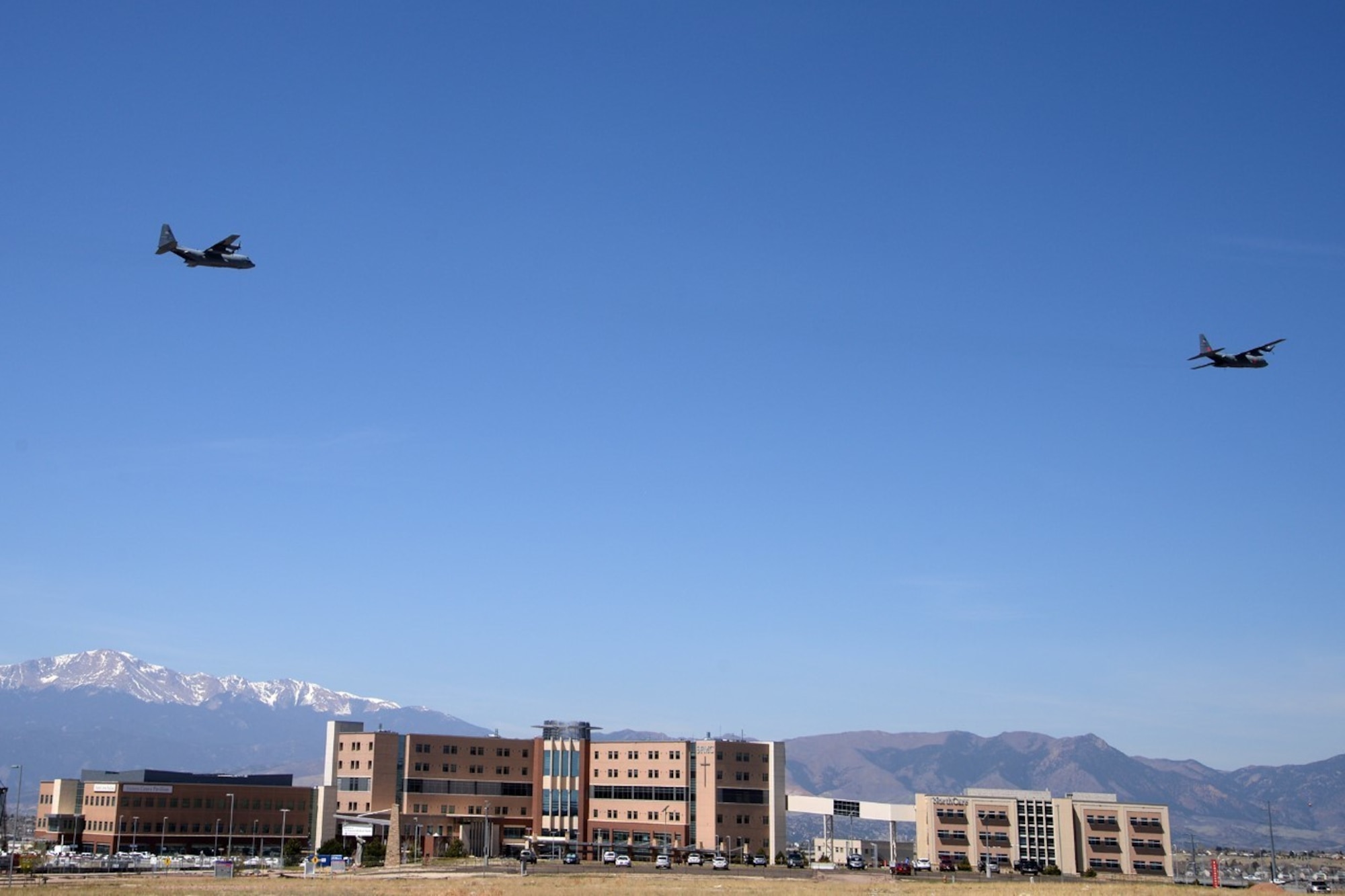 Image shows two large aircraft flying over Colorado Springs hospital