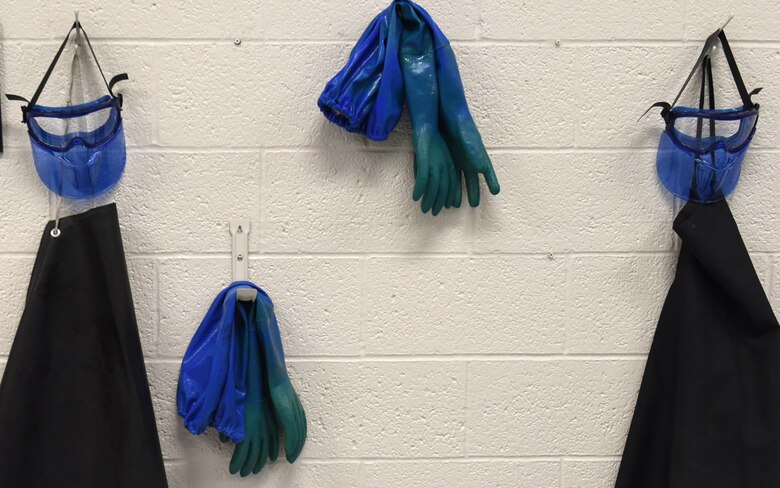 A photo of protective equipment  hung on a wall.