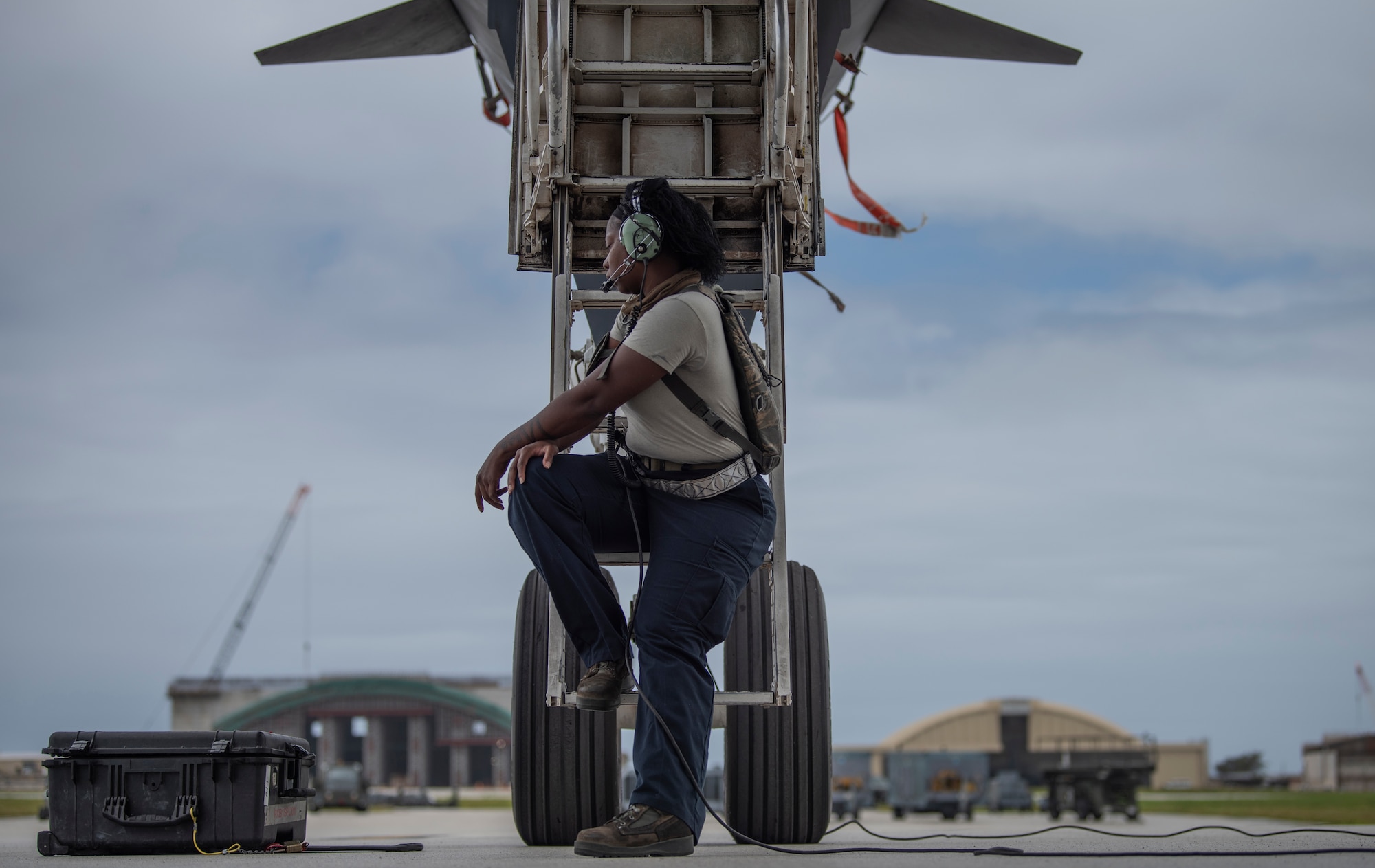 Senior Airman Raisa Ward, 9th Expeditionary Bomb Squadron Aircraft Maintenance Unit avionics technician, sits under a 9th EBS B-1B Lancer at Andersen Air Force Base, Guam, May 5, 2020, after completing maintenance on the aircraft. The 9th EBS, and other units assigned to the 7th Bomb Wing of Dyess Air Force Base, Texas, are deployed to Guam as part of a Bomber Task Force. BTFs contribute to joint force lethality, assure allies and partners, and deter aggression in the Indo-Pacific. (U.S. Air Force photo by Senior Airman River Bruce)