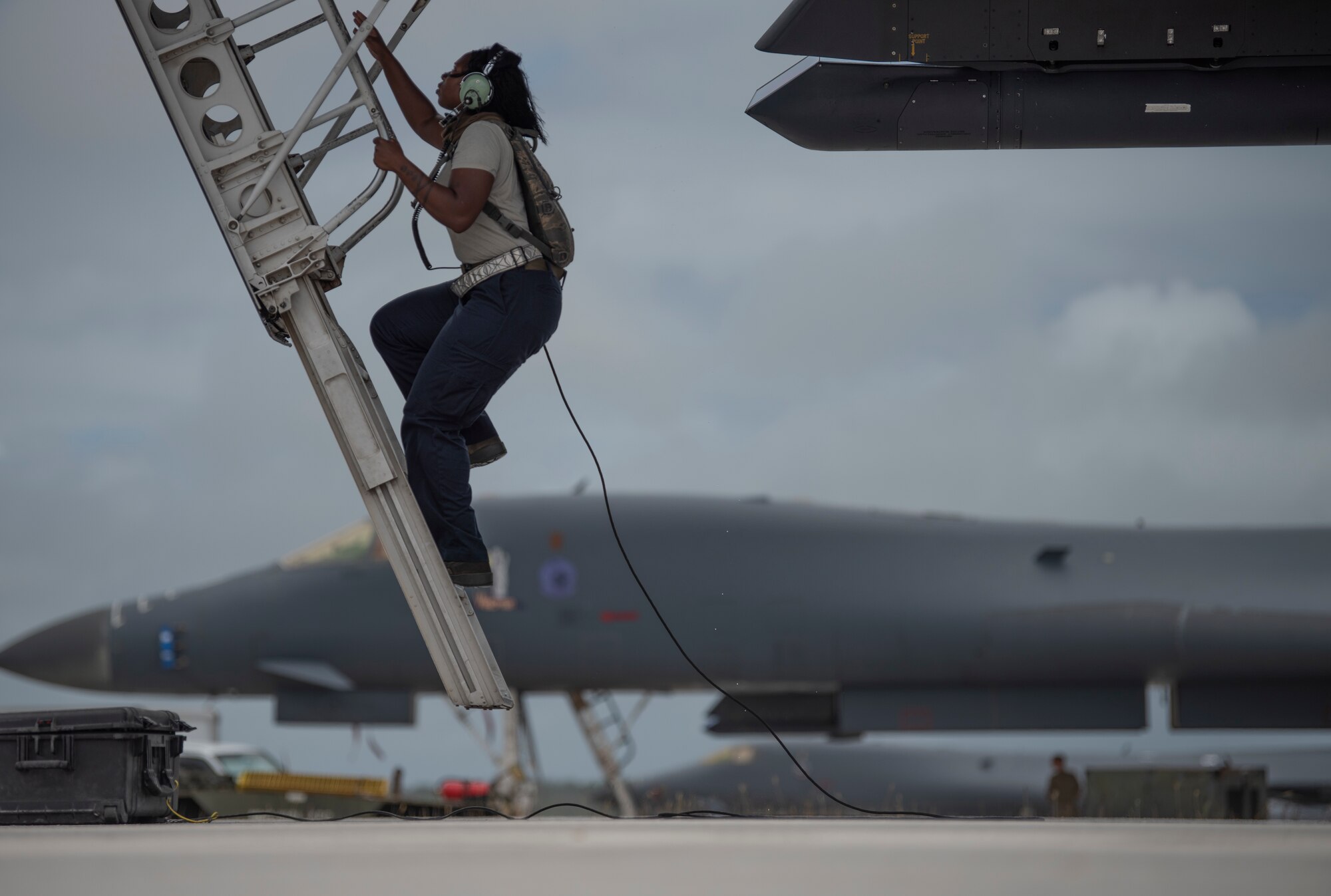 Senior Airman Raisa Ward, 9th Expeditionary Bomb Squadron Aircraft Maintenance Unit avionics technician, climbs into a 9th EBS B-1B Lancer to conduct maintenance at Andersen Air Force Base, Guam, May 5, 2020. This BTF supports the National Defense Strategy objectives of strategic predictability and operational unpredictability.  (U.S. Air Force photo by Senior Airman River Bruce)