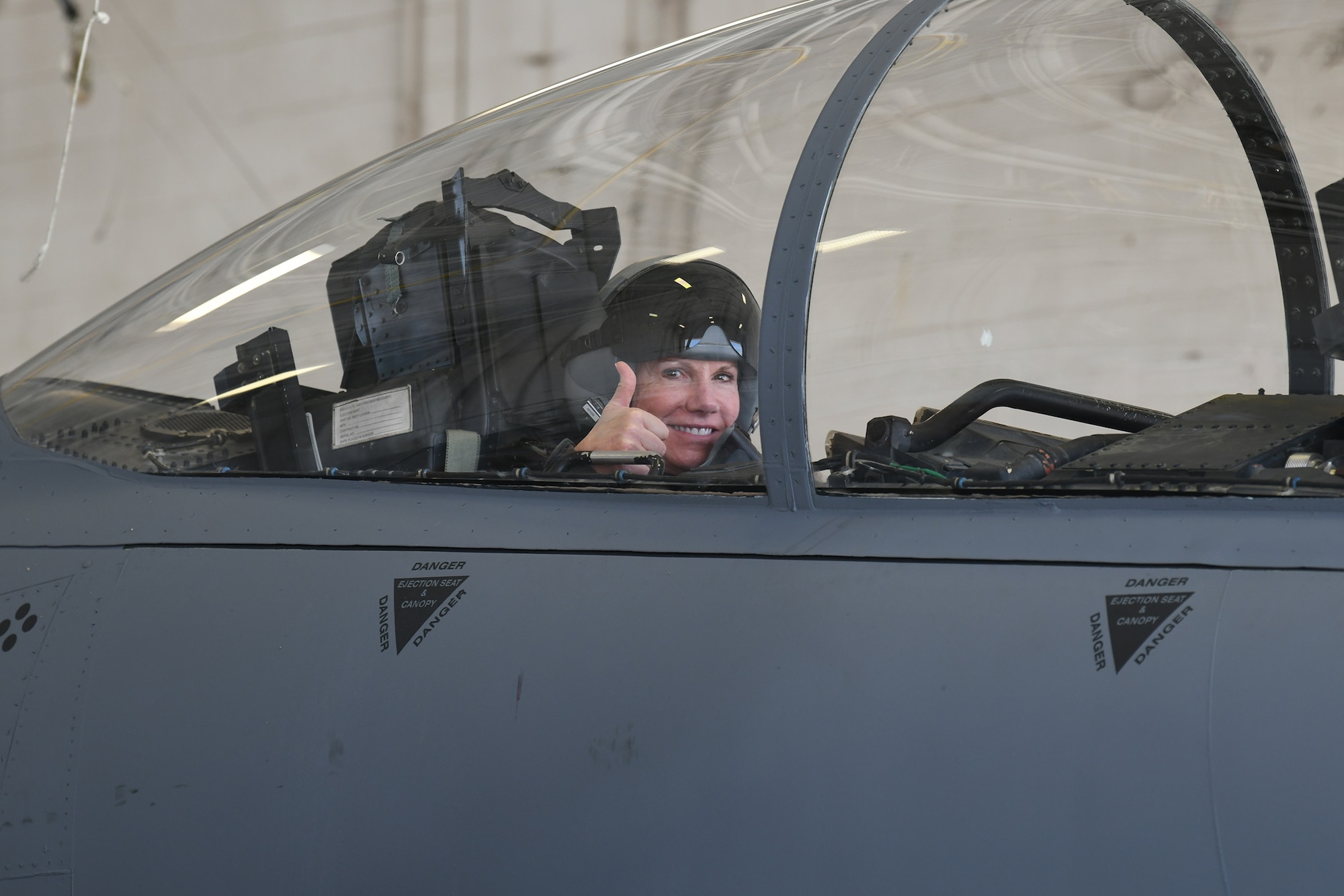 Photo shows Col. Farrell sitting in the cockpit of an F-15 giving a thumbs up.