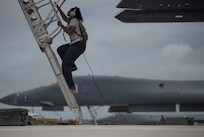 Senior Airman Raisa Ward, 9th Expeditionary Bomb Squadron Aircraft Maintenance Unit avionics technician, climbs into a 9th EBS B-1B Lancer to conduct maintenance at Andersen Air Force Base, Guam, May 5, 2020. This BTF supports the National Defense Strategy objectives of strategic predictability and operational unpredictability.  (U.S. Air Force photo by Senior Airman River Bruce)