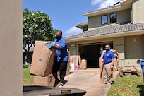 Household goods inspector Faata Leafa performs an inspection of a household goods packout performed by Aloha International. They all are practicing social distancing and wearing facemasks.