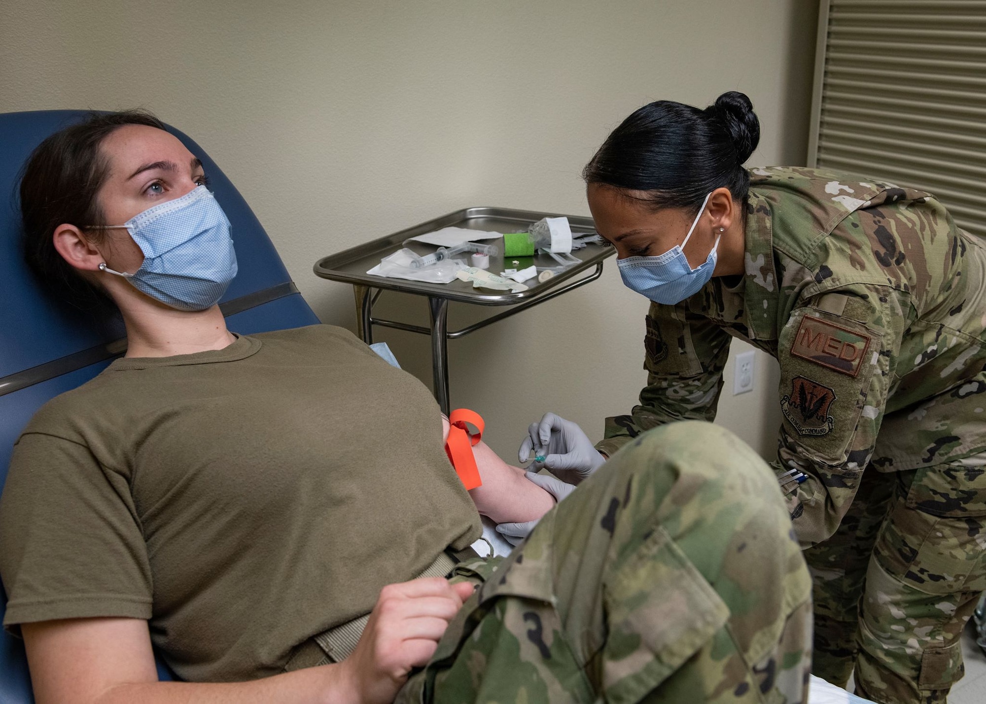 U.S. Air Force Tech. Sgt. Ulla Strömberg, 9th Health Care Operations Squadron Family Care Flight section chief, right, prepares an intravenous access for Staff Sgt. Marissa Smyth, 9th HCOS Family Health Clinic NCOIC, at Beale Air Force Base, California, May 1, 2020. Strömberg was demonstrating the proper procedures for training purposes. (U.S. Air Force photo by Airman Jason W. Cochran)